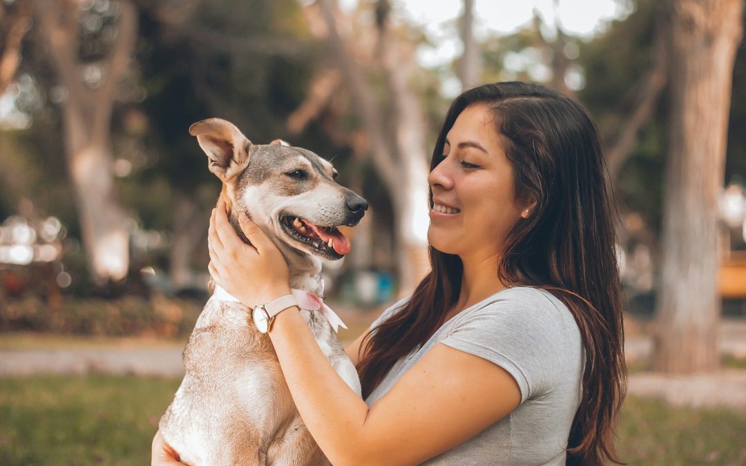woman playing with dog
